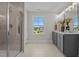 Bathroom featuring double sinks, a large shower, and a window with a neighborhood view at 15 Diamond Creek Dr, Zebulon, NC 27597