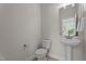 Powder room featuring a pedestal sink, modern fixtures, and natural light at 15 Diamond Creek Dr, Zebulon, NC 27597