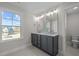 Bathroom featuring a double sink vanity, stylish fixtures, and a large window providing ample natural light at 15 Diamond Creek Dr, Zebulon, NC 27597