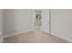 Bright bedroom featuring wood-look floors and a view to another room with neutral decor at 15 Diamond Creek Dr, Zebulon, NC 27597