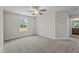 A carpeted bedroom offers a ceiling fan for comfort and a large window view at 15 Diamond Creek Dr, Zebulon, NC 27597
