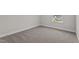 A carpeted bedroom offers natural light from a large window at 15 Diamond Creek Dr, Zebulon, NC 27597
