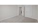 Bedroom featuring carpeted floors, neutral walls, and doorway to hallway at 15 Diamond Creek Dr, Zebulon, NC 27597