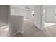 A bright bedroom features neutral carpet, white walls and trim, ceiling fan, and view of the outdoors from the window at 15 Diamond Creek Dr, Zebulon, NC 27597