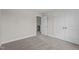 This carpeted bedroom provides ample closet space and an open doorway view at 15 Diamond Creek Dr, Zebulon, NC 27597