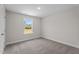 This cozy bedroom boasts plush carpeting, a window with a view, and neutral paint at 15 Diamond Creek Dr, Zebulon, NC 27597
