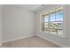 Empty bedroom with light wood flooring and a large window overlooking the neighborhood at 15 Diamond Creek Dr, Zebulon, NC 27597
