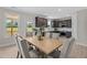 Inviting dining area with a large wooden table, seating for six, and an open view into the kitchen at 15 Diamond Creek Dr, Zebulon, NC 27597