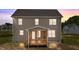 Back of a two-story house with a covered back porch at sunset at 15 Diamond Creek Dr, Zebulon, NC 27597