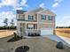 Two-story house with a neutral color scheme, a two-car garage, and a landscaped yard at 15 Diamond Creek Dr, Zebulon, NC 27597
