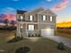 Two-story house with a neutral color scheme, a two-car garage, and a landscaped yard at 15 Diamond Creek Dr, Zebulon, NC 27597