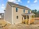 Two-story home showcasing vinyl siding and a wooden porch with steps at 15 Diamond Creek Dr, Zebulon, NC 27597