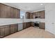 Modern kitchen with dark brown cabinets, white backsplash, and stainless steel appliances at 15 Diamond Creek Dr, Zebulon, NC 27597