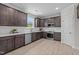 Modern kitchen featuring stainless steel appliances, dark wood cabinets, and white subway tile backsplash at 15 Diamond Creek Dr, Zebulon, NC 27597