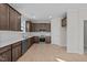 Modern kitchen with dark brown cabinets, white backsplash, and stainless steel appliances at 15 Diamond Creek Dr, Zebulon, NC 27597