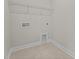 Small laundry room featuring tile floors, and a wire rack shelf on the wall at 15 Diamond Creek Dr, Zebulon, NC 27597