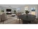 Comfortable living room with large windows, neutral tones, and an open floor plan into dining area at 15 Diamond Creek Dr, Zebulon, NC 27597