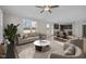 Bright and airy living room flows into a modern kitchen with stainless steel appliances and a breakfast bar at 15 Diamond Creek Dr, Zebulon, NC 27597