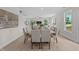 Bright open-concept living and dining area with modern decor, large windows, and lots of natural light at 15 Diamond Creek Dr, Zebulon, NC 27597