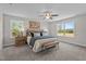 Spacious main bedroom with a comfortable king-size bed, ceiling fan, and a great view from the large windows at 15 Diamond Creek Dr, Zebulon, NC 27597