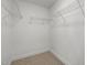 Empty walk-in closet with wire shelving and plush carpet at 15 Diamond Creek Dr, Zebulon, NC 27597