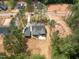 A high aerial view of the home with a wooded lot, long driveway, and an adjacent foundation under construction at 205 Purslane Dr, Franklinton, NC 27525
