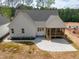 Exterior view of the home with a concrete patio, screened porch, and newly landscaped yard at 205 Purslane Dr, Franklinton, NC 27525