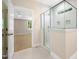 Bathroom showcases a tiled shower with corner glass and a view of the primary bedroom at 205 Purslane Dr, Franklinton, NC 27525