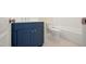 Bathroom featuring a navy vanity cabinet and a toilet beside a tub with shower at 205 Purslane Dr, Franklinton, NC 27525