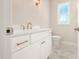 Well-lit bathroom featuring a white vanity with gold fixtures and pulls, complemented by stylish marble flooring at 205 Purslane Dr, Franklinton, NC 27525