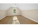 This bedroom features wood-look flooring and a large window overlooking greenery at 205 Purslane Dr, Franklinton, NC 27525