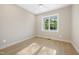 Bright bedroom with wood flooring, neutral paint, a ceiling fan, and a large window overlooking the greenery at 205 Purslane Dr, Franklinton, NC 27525