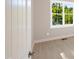 Bright bedroom featuring wood flooring, a large window, neutral wall paint, and white trim at 205 Purslane Dr, Franklinton, NC 27525