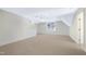 This bonus room features neutral carpet, a ceiling fan, and a large window at 205 Purslane Dr, Franklinton, NC 27525