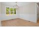 Dining room featuring wainscoting, a modern chandelier, and view of the exterior at 205 Purslane Dr, Franklinton, NC 27525