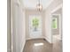 Bright entryway with wood floors, white trim, stylish light fixture, and a windowed front door at 205 Purslane Dr, Franklinton, NC 27525