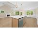 Spacious kitchen island featuring a white countertop and gold hardware with a view of the living room at 205 Purslane Dr, Franklinton, NC 27525