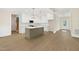 Open concept kitchen with an island, white cabinets, and stainless steel appliances at 205 Purslane Dr, Franklinton, NC 27525