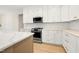 Kitchen featuring stainless appliances, white cabinetry with gold hardware, and island at 205 Purslane Dr, Franklinton, NC 27525