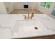 Kitchen island featuring a farmhouse sink, with a gold faucet and hardware at 205 Purslane Dr, Franklinton, NC 27525
