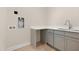 Bright laundry room featuring white cabinets and countertops and stainless steel sink at 205 Purslane Dr, Franklinton, NC 27525