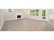 Bright living room features a fireplace, large windows, and stylish flooring at 205 Purslane Dr, Franklinton, NC 27525