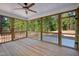 A screened porch with wood flooring and ceiling that overlooks a wooded area at 205 Purslane Dr, Franklinton, NC 27525