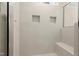 An elegant shower featuring tile surround with built-in shelving and a bench at 205 Purslane Dr, Franklinton, NC 27525