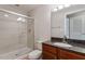 Bright bathroom featuring a tiled stand-up shower, vanity with a granite countertop, and a toilet at 222 Glenwood Ave # 508, Raleigh, NC 27603