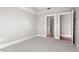 Empty bedroom with neutral carpet and adjoining bathroom at 222 Glenwood Ave # 508, Raleigh, NC 27603