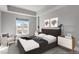 Staged bedroom with modern furniture, large window and gray walls at 222 Glenwood Ave # 508, Raleigh, NC 27603