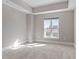 Empty bedroom featuring a large window and neutral walls at 222 Glenwood Ave # 508, Raleigh, NC 27603