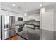 Modern kitchen featuring stainless steel appliances, a tile backsplash, and granite countertops with pendant lighting at 222 Glenwood Ave # 508, Raleigh, NC 27603