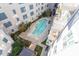 Aerial view of a community pool surrounded by lush landscaping and building balconies at 222 Glenwood Ave # 508, Raleigh, NC 27603